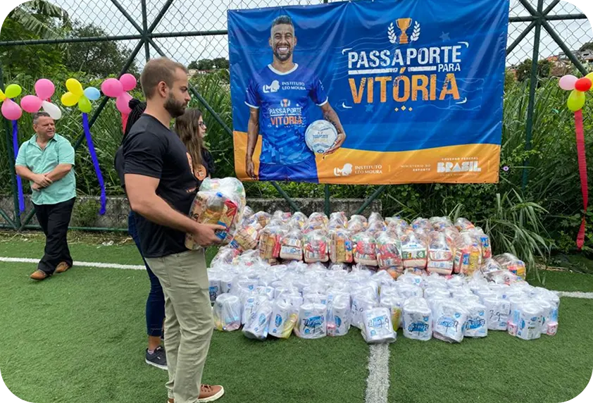 Flávio Ribeiro carregando cestas básicas na entrega para o projeto Passaporte para a Vitória, em Barra Mansa